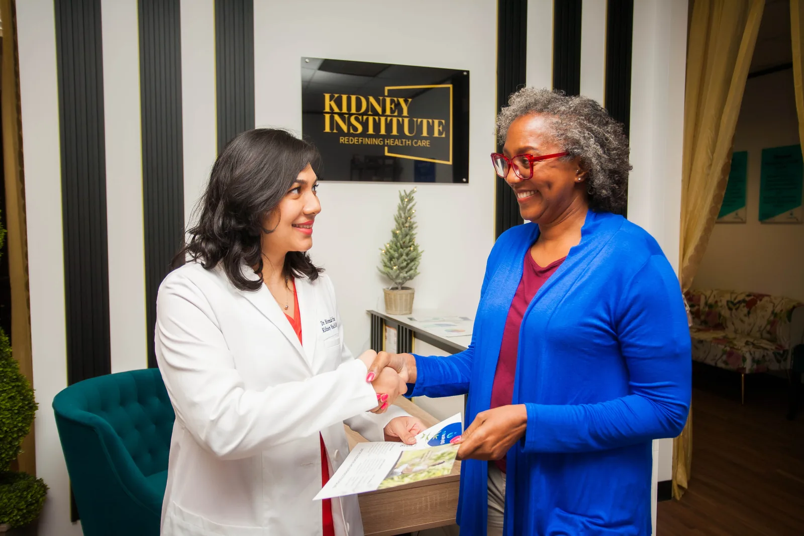 Dr. Bismah Irfan welcoming a patient at the clinic reception in Houston